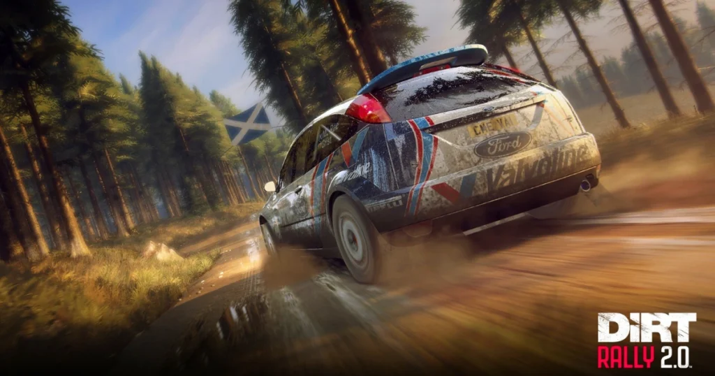 A video game screenshot of DiRT Rally 2.0, featuring a Ford Focus RS WRC 02 speeding through a muddy forest track. The car is covered in dirt and water splashes, emphasizing the intensity of the rally. The Scottish flag is visible in the background.