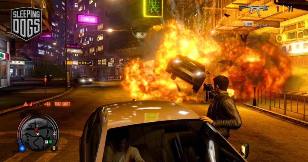 A video game screenshot of Sleeping Dogs, showcasing a chaotic street fight in a neon-lit, rain-soaked Hong Kong alleyway. The protagonist, Wei Shen, is engaged in a hand-to-hand combat with a group of Triad members, while a car explodes in the background.