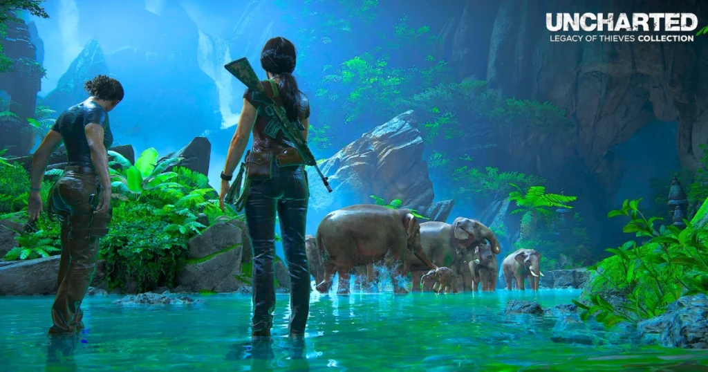 A video game screenshot featuring Chloe Frazer and Nadine Ross, the protagonists of Uncharted: The Lost Legacy, standing in a lush, tropical jungle. They are armed and looking at a herd of elephants drinking from a small pond. The game logo, "UNCHARTED LEGACY OF THIEVES COLLECTION," is displayed prominently at the top.